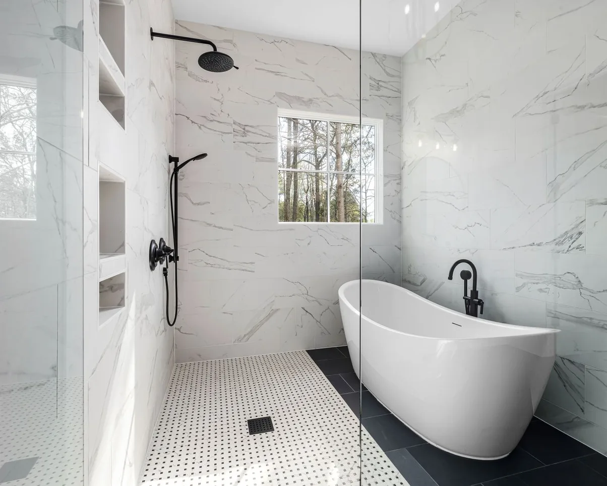 A marble bathroom with a freestanding tub and a walk-in shower